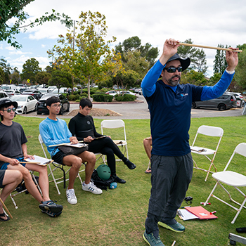 A group of students sitting with an instructor