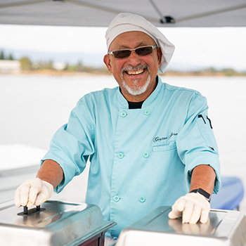 A server getting ready to serve food.